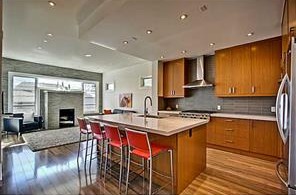 2007 40 Avenue SW, open kitchen with teak cabinetry and quartz island